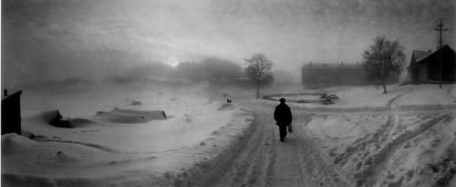 Pentti Sammallahti Black and White Photograph - Solovki, White Sea, Russia (Man Walking Down Snow Covered Road)