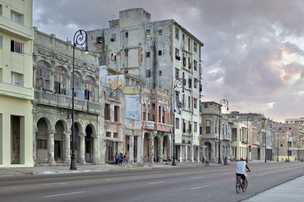 Jeffrey Milstein Color Photograph - Bicycle on the Malecon, Havana, Cuba