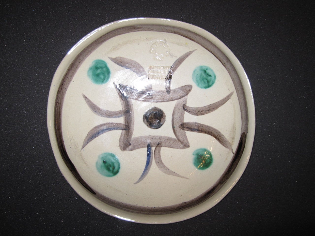 Glazed ceramic plate from the edition of 25 with a second design verso. Stamped Empreinte Originale de Picasso, Madoura Plein Feu verso.

Reference: Catalogue raisonne Ramie 88
