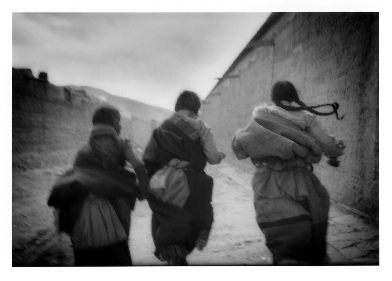James Whitlow Delano Black and White Photograph - Tibetan Girls Running, Labrang, Amdo, Tibet