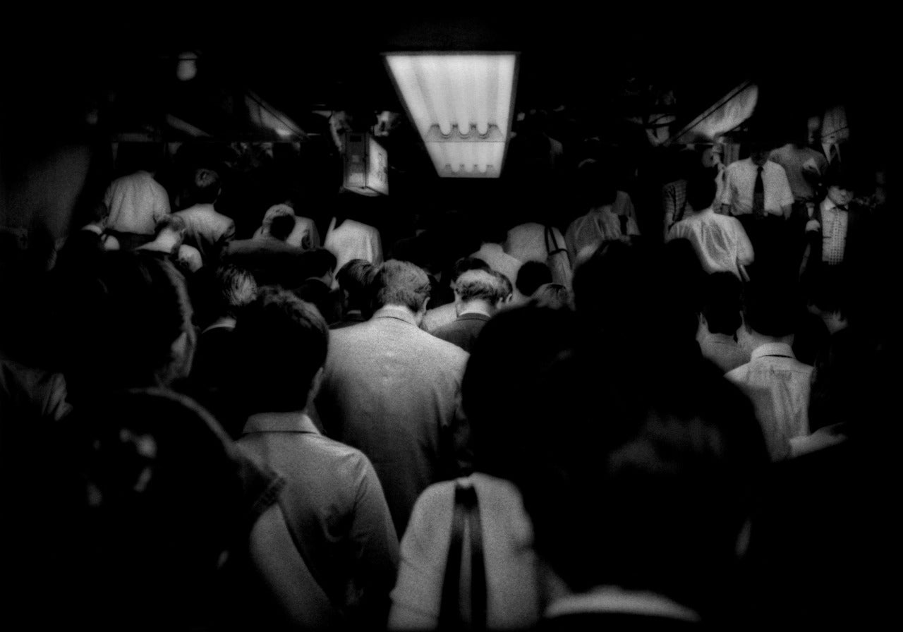 James Whitlow Delano Black and White Photograph - Relentless flow of Tokyo commuters up to the subway