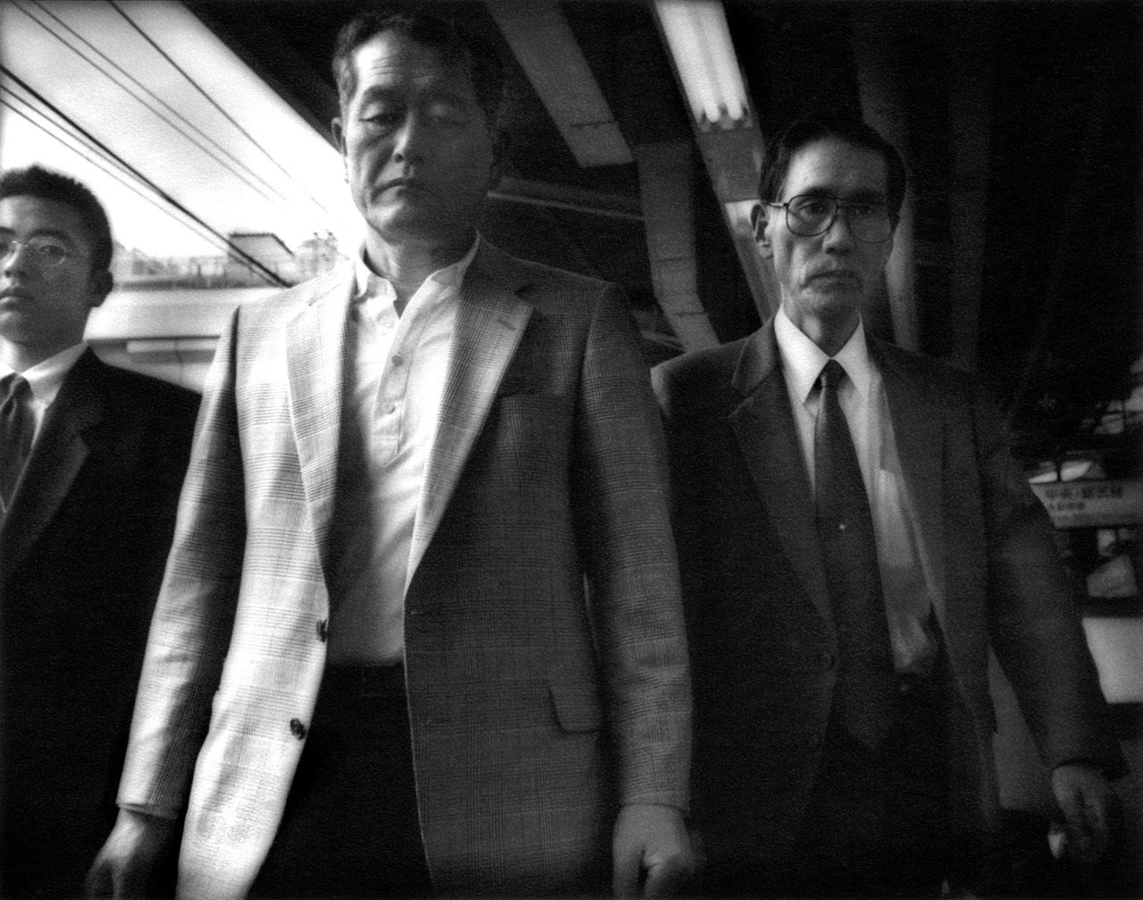James Whitlow Delano Black and White Photograph - Salarimen, Yamanote Line, Shinjuko, Tokyo
