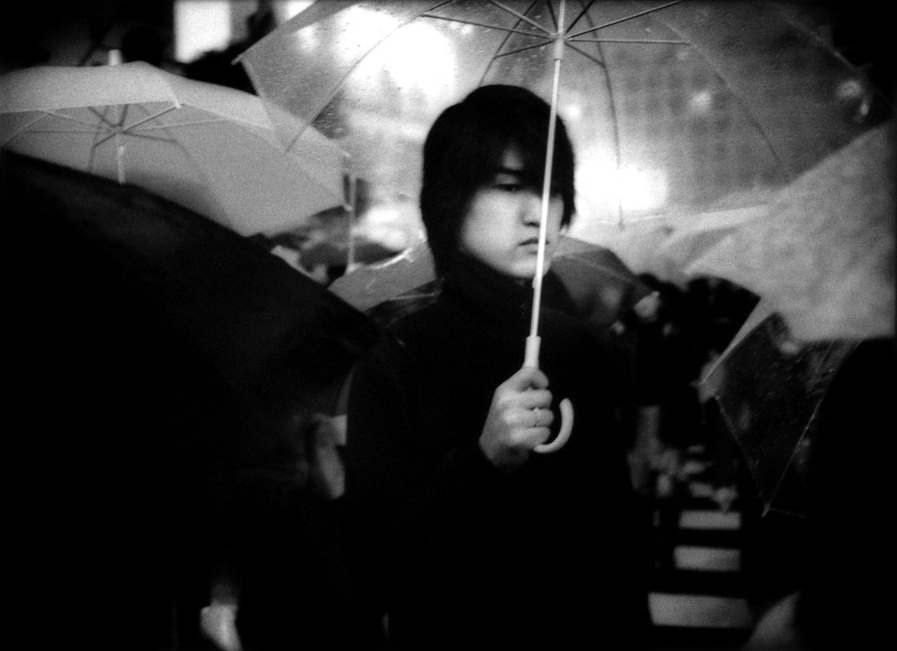 James Whitlow Delano Portrait Photograph - Under umbrella in nighttime rain, Hachiko Shibuya, Tokyo