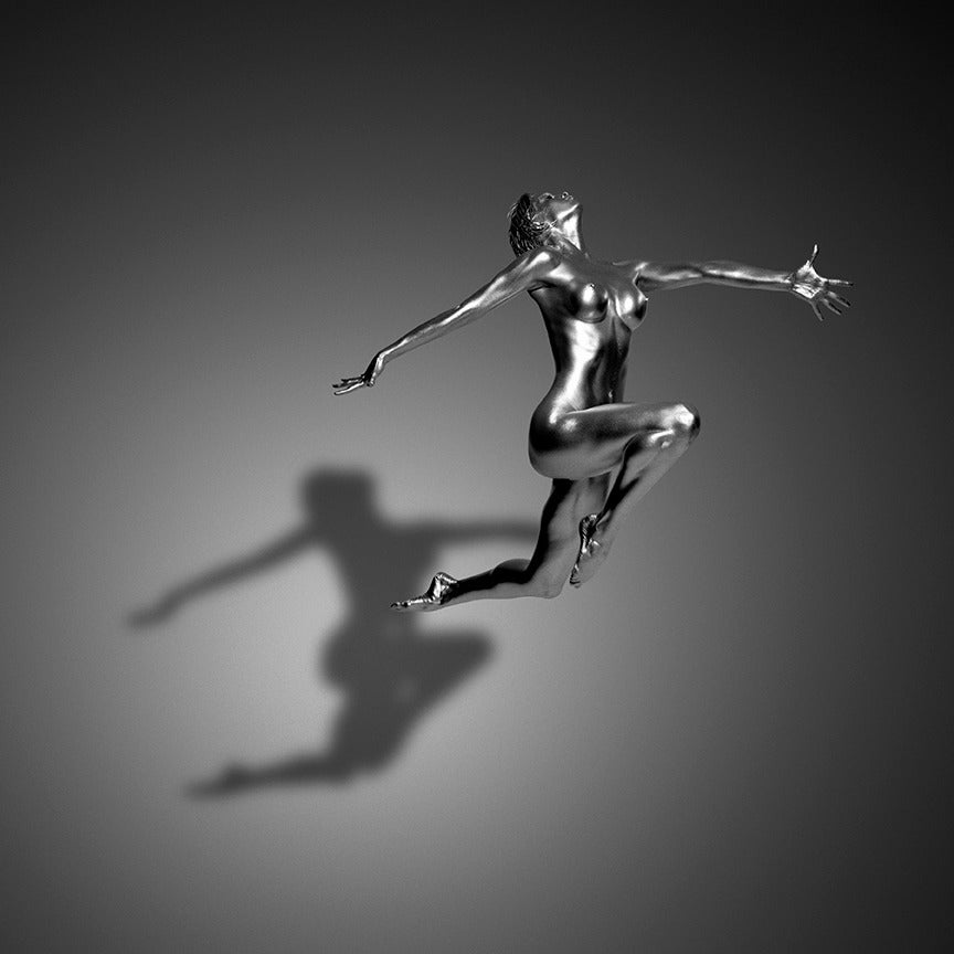 Guido Argentini Color Photograph - Elen - the model in silver, jumping in the air nude