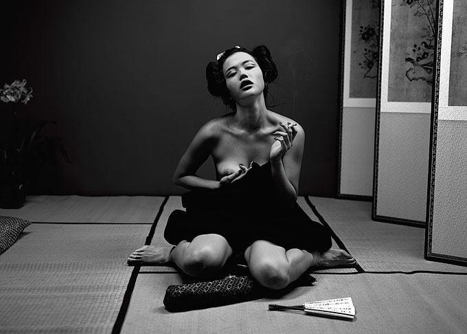 Michel Comte Portrait Photograph - Ling, Arude Magazine - nude asian model sitting on floor with cigarette in hand
