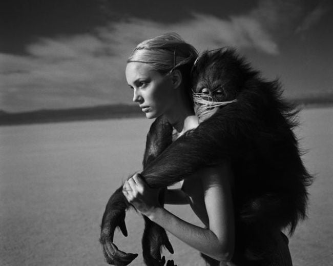 Michel Comte Black and White Photograph - Beauty and Beast I - model with a monkey on her back in desert