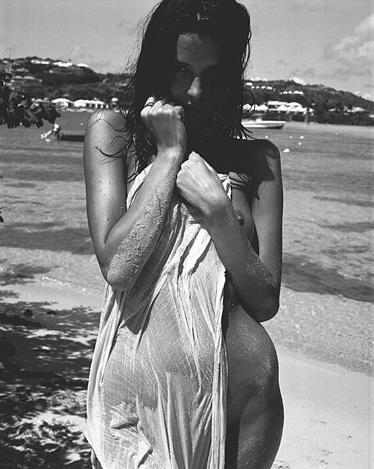 Marc Baptiste Nude Photograph - Saint Barts - model standing naked on the beach with a towel