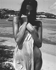 Saint Barts - model standing naked on the beach with a towel