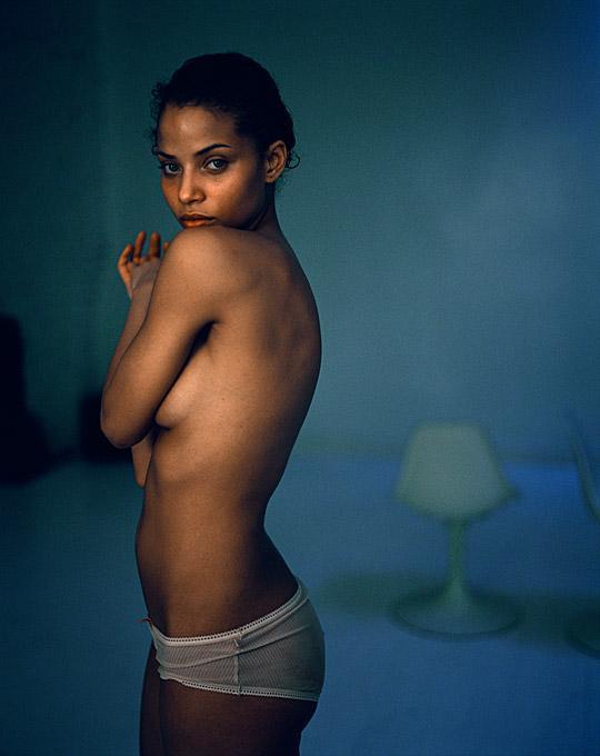 Marc Baptiste Color Photograph - Vasi the nude model with a underwear standing in a blue room