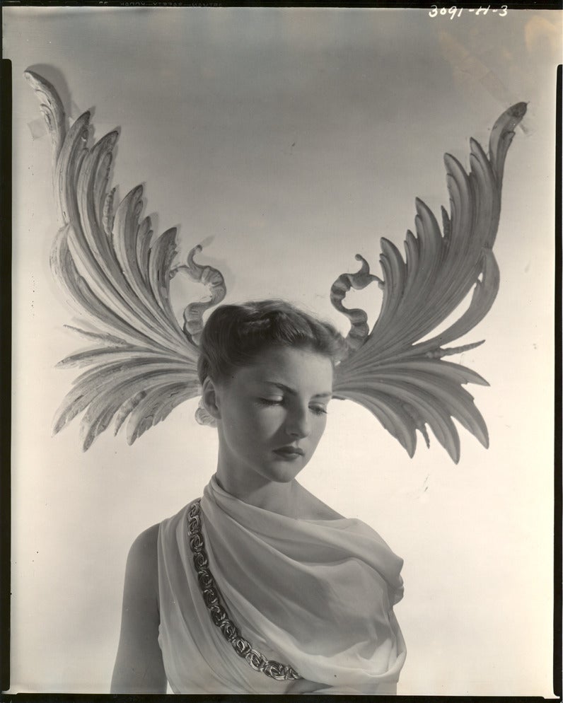 Horst P. Horst Figurative Photograph - Grecian model and winged background.