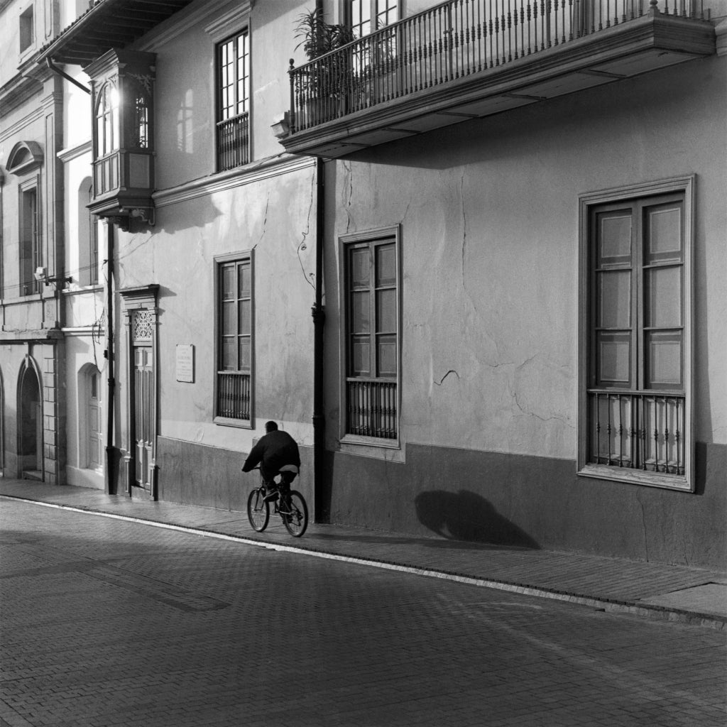 Mario Algaze Black and White Photograph - La Sombra del Ciclista, Bogota, Colombia