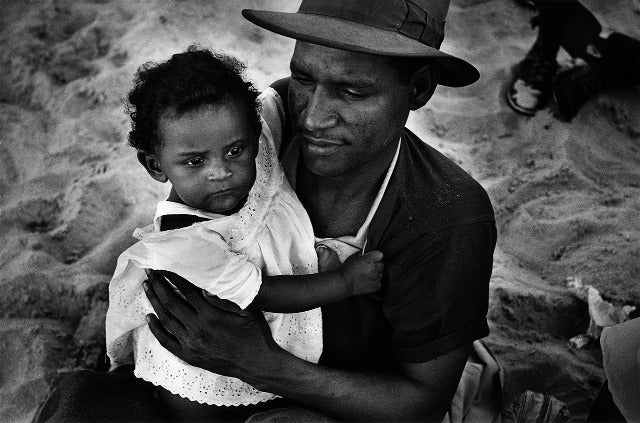 Harold Feinstein Black and White Photograph - Father and Baby Daughter on the Beach, Coney Island