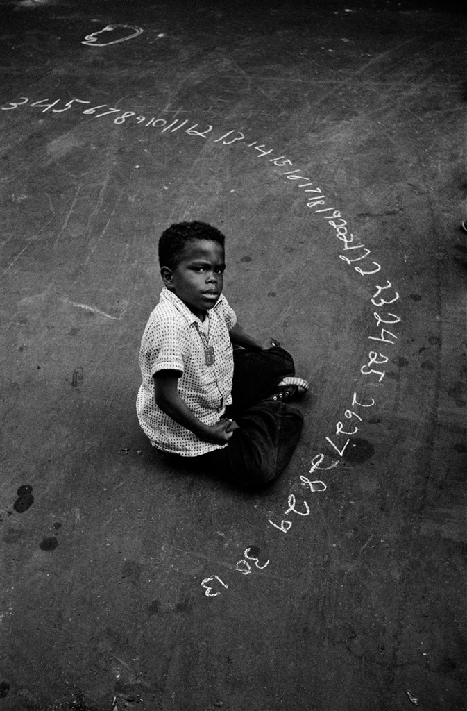 Harold Feinstein Portrait Photograph - Boy with Chalked Numbers, NYC