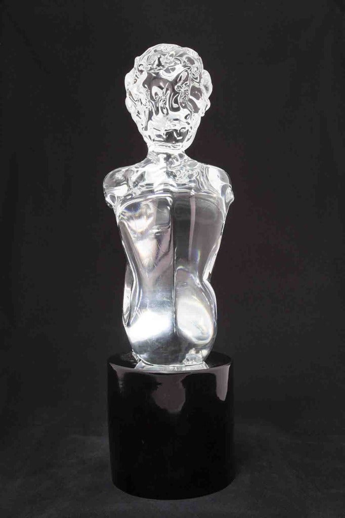 This is a blown Murano glass sculpture of a kneeling boy by the Italian artist Loredano Rosin. Glass is an exotic and enticing art medium. Hot or molten glass is a sensitive, amorphous material that is shaped by blowing, casting, or pressing into