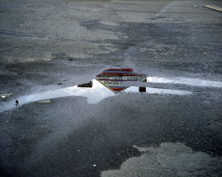 Lisa Kereszi Color Photograph - Topless bar reflected in puddle, Doylestown, PA 2010