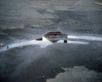 Topless bar reflected in puddle, Doylestown, PA 2010