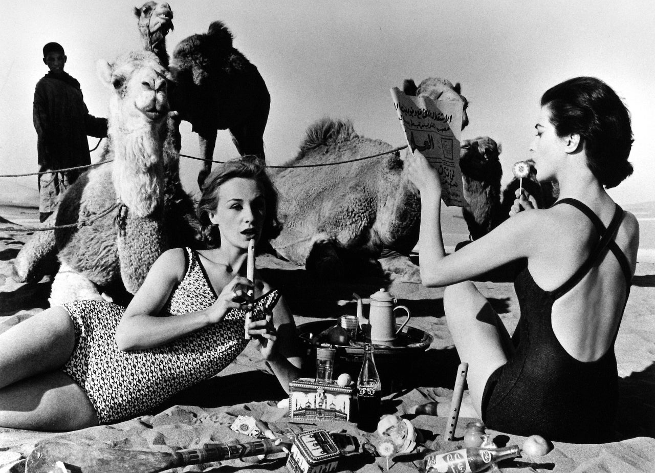 Tatiana + Marie Rose + Camels, Picnic, Morocco - Photograph by William Klein