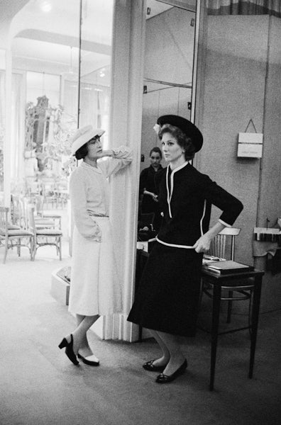 Mark Shaw Black and White Photograph - Coco Chanel with Suzy Parker in a Dark Suit