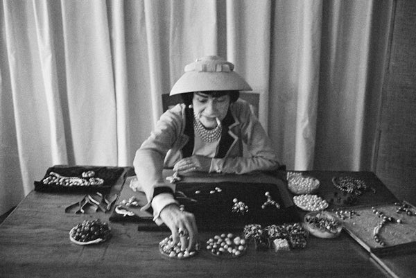 Mark Shaw Black and White Photograph - Coco Chanel Creates Jewelry In Her Workroom