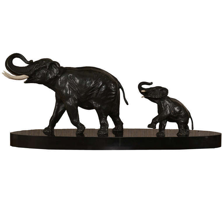 Two indian elephants in bronze with ivory tusks surmounted on black marble, probably made in Vienna.