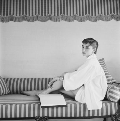 Mark Shaw Portrait Photograph - Audrey Hepburn on Striped Sofa , 1954