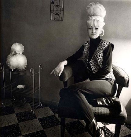 Diane Arbus Black and White Photograph - Lady Bartender at Home with a Souvenir Dog, New Orleans, Louisiana, 1964