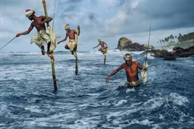 Fishermen, Weligama, South Coast, Sri Lanka, 1995 - Steve McCurry
Signed and affixed with photographer's edition label and numbered on reverse
Digital c-type print
Printed on 20 x 24 inch paper
Edition of 90

Steve McCurry (born 1950) is best known