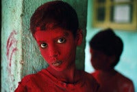 Vintage Red Boy during Holi festival. Bombay, India.