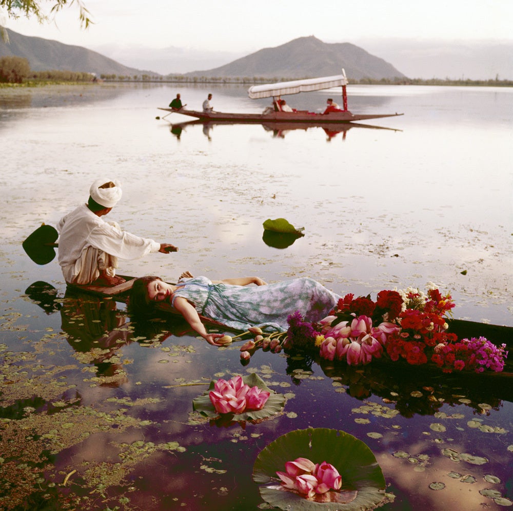 Floating with flowers, India, Vogue. Barbara Mullen floating in a cotton mousseline dress by Atrima. - Photograph by Norman Parkinson