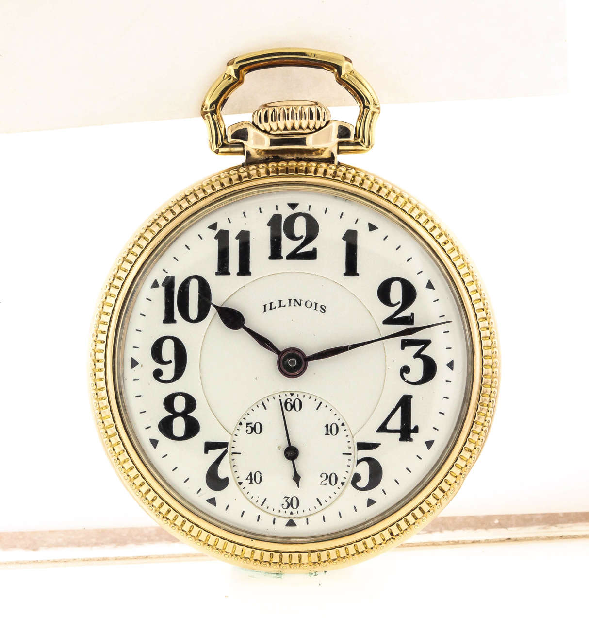 Gold-filled Illinois Bunn Special pocket watch, circa 1927. The 51mm case has a screw bezel and back, by Wadsworth. The white enamel dial features bold Arabic numerals, outer minute ring, subsidiary seconds, and blued steel spade hands. The movement