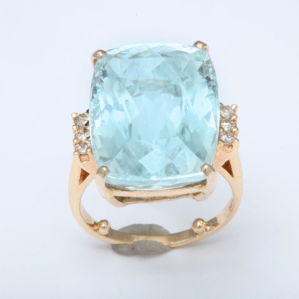 A spectacular faceted light color Emerald cut Aquamarine approx 16 ct,  14 kt gold ring flanked by diamonds