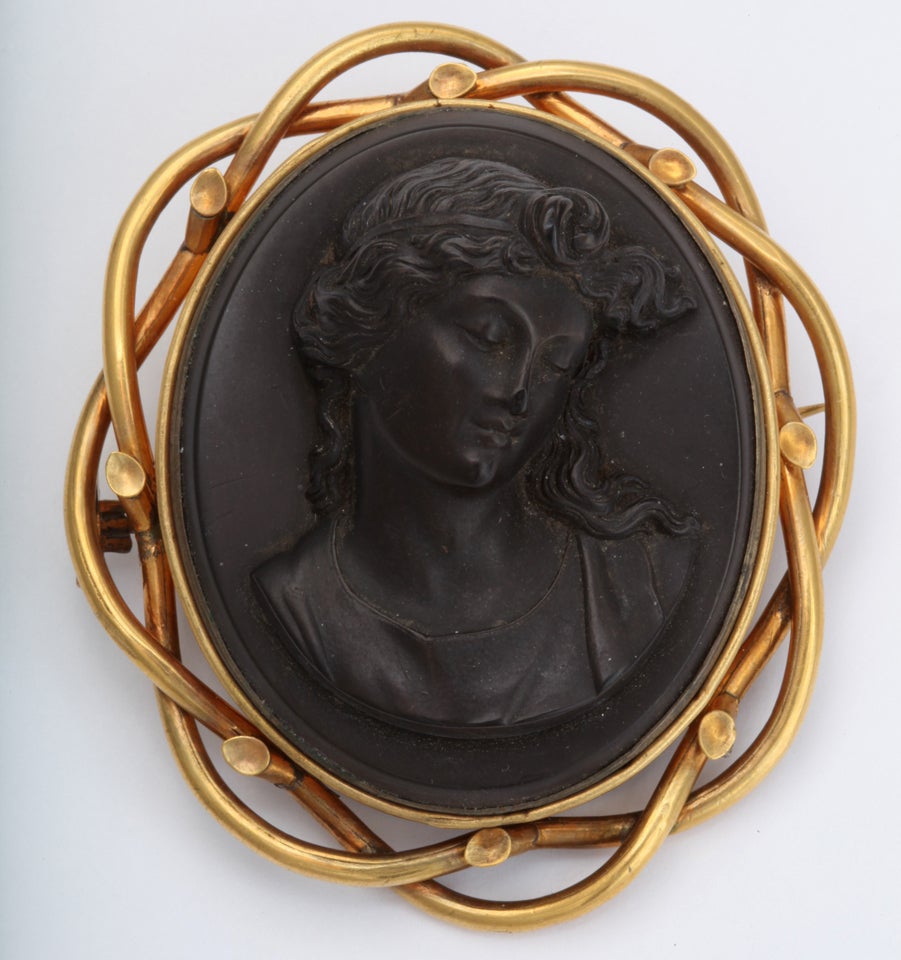 A fabulous  Gutta  Percha carved cameo Surrounded by a gold filled weave