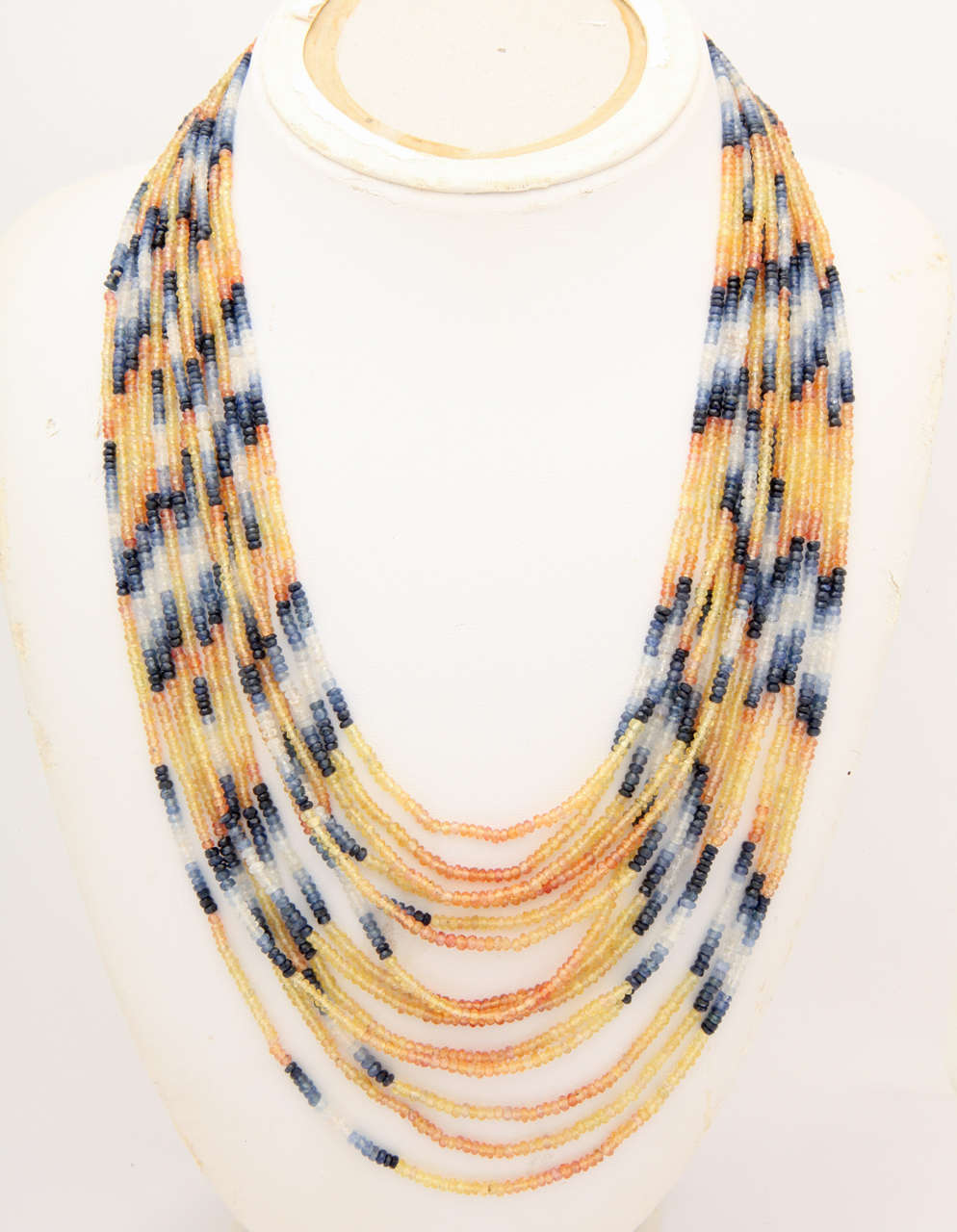 These 14 strands of faceted multi colored sapphire beads sparkle beautifully. The necklace drapes elegantly around the neck. The clasp is 22 kt gold with a toggle clasp. The beads are about 375 cts . The length of the shortest strand is 19 in. and