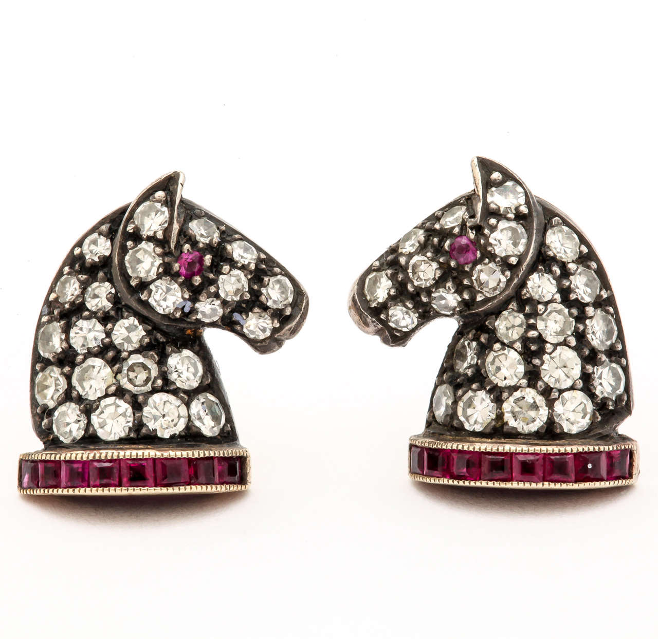 These silver and 18 kt gold horse head earring studs are set with 1 ct white diamonds and .25 ct square cut top quality rubies. These stunning earrings will grace the ears of an elegant equestrian for any occasion, day or night.