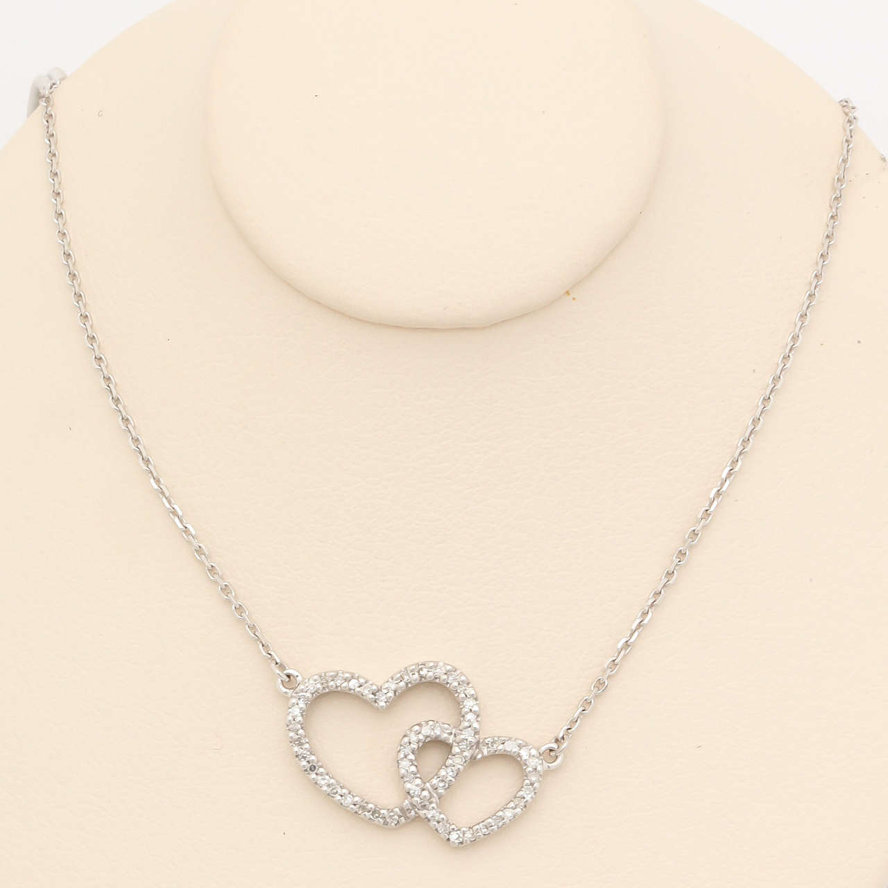 What a charming gift for Valentines Day. This 14 kt white gold and 0.17 ct diamond pendant is a wonderful token of your love. Your lives are intertwined for eternity.The chain is 16.5 in. 14 kt white gold cable-link made in Italy. A perfect memento