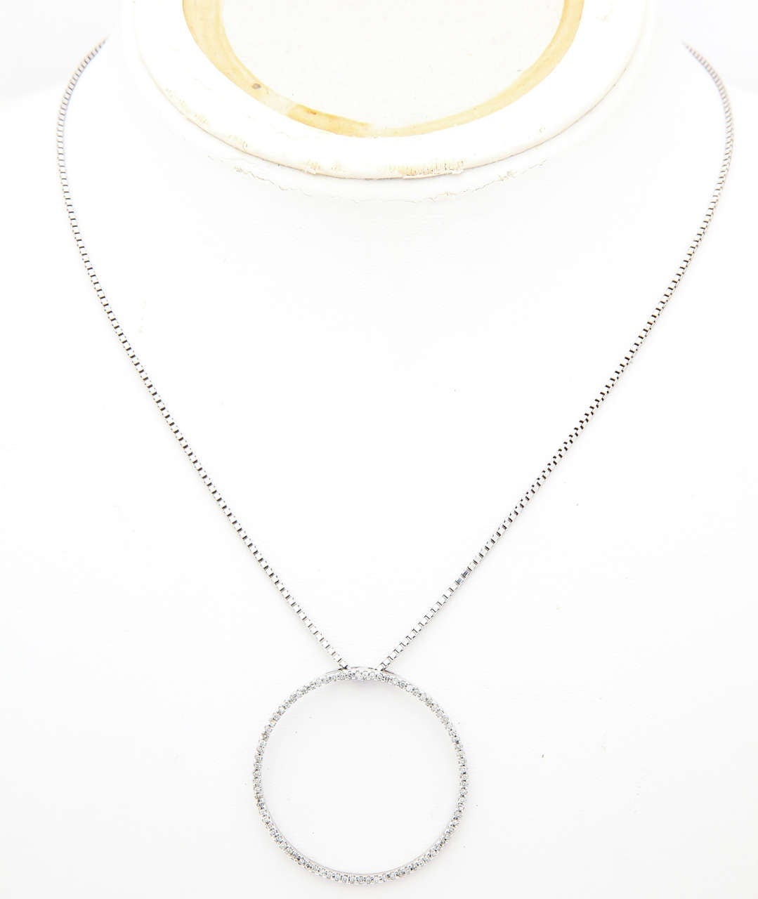 The Circle of Love pendant forms a perfect circle with no beginning and no end signifying your love. It is a promise of everlasting devotion, never to be broken. The pendant and chain are 14 kt white gold with 0.35 cts white diamond micro-pave set.