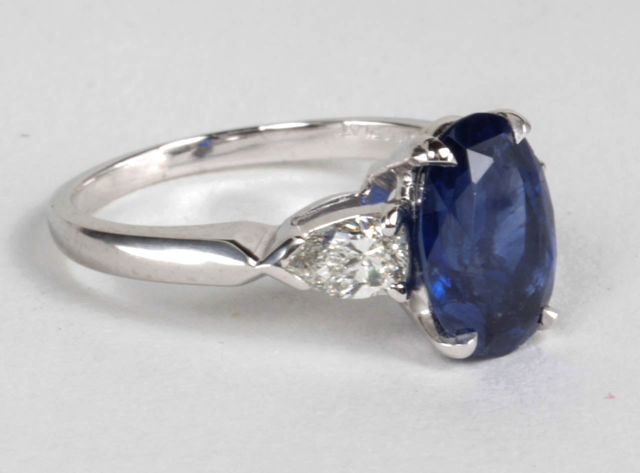 Beautiful 2.92 carat oval blue sapphire set with .50 carats of pear shaped white diamonds. Custom platinum setting.