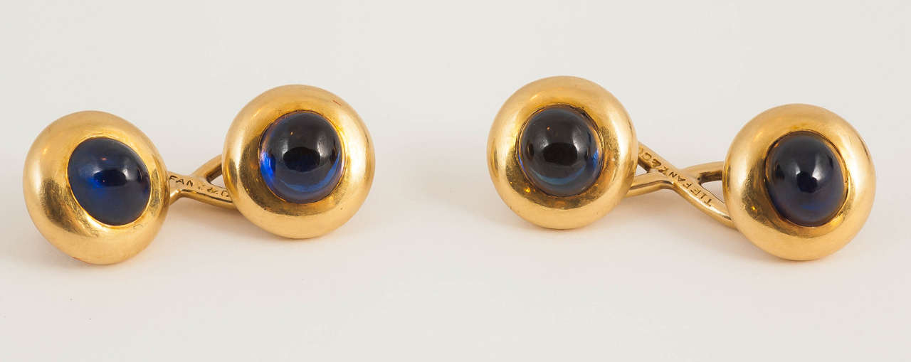 A fine and heavy pair of gold mounted Cabochon sapphire cufflinks of excellent colour.signed Tiffany & Co.