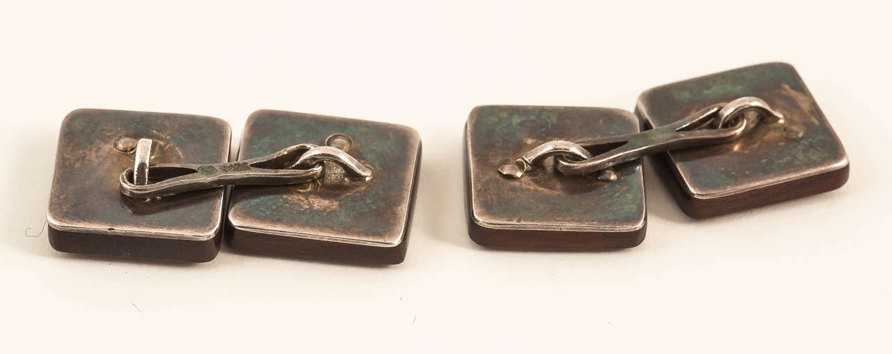 An unusual pair of antique double sided cufflinks with silver (925s) game motifs of a Fox, Capercaillie, Stag and Hare mounted on bog oak (a type of wood).
Measures 13mm across.
Antique piece (over 100 years old) in the Edwardian style.
20th