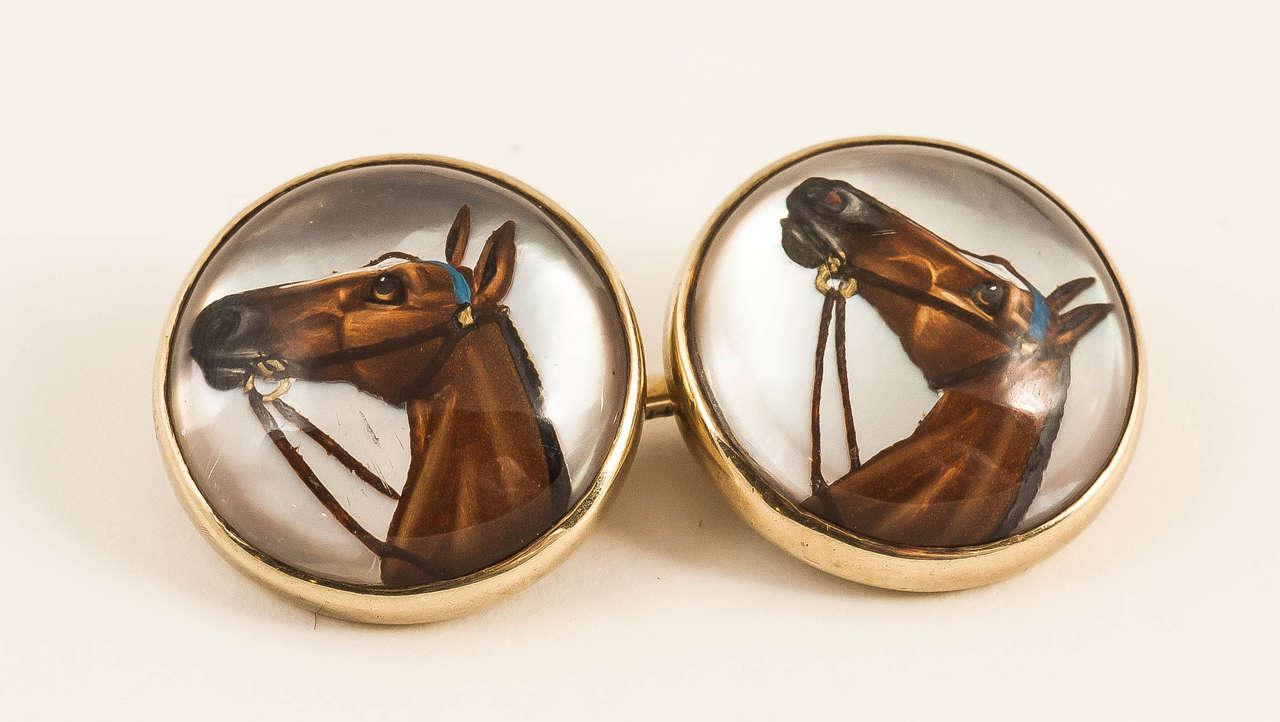 A finely painted pair of Racehorse head cufflinks with mother of pearl background,mounted in 14k gold