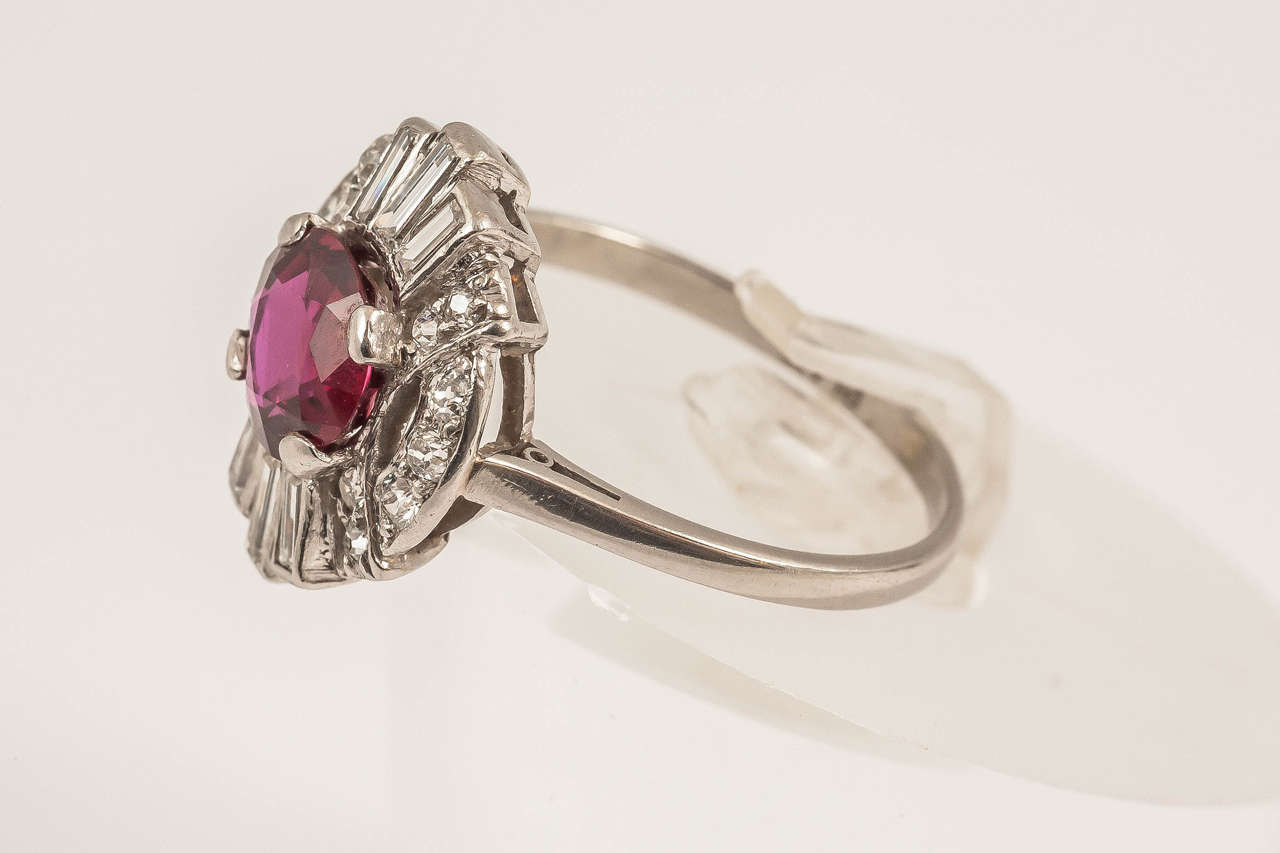 Platinum set Art Deco Central set Ruby with Diamond surround. Ruby shows no evidence of enhancement. Ring has a Gubelin certificate

Finger size N