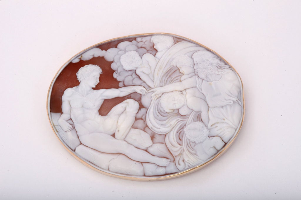 Hand carved oversize Shell Cameo with a detail of Adam reaching out to God amidst clouds & Putt. Detail from the Sistine Chapel Ceiling.i  Superb carving and mounted in a handmade 14kt Yellow Gold mounting .  Bearing Italian assay marks, Italy &