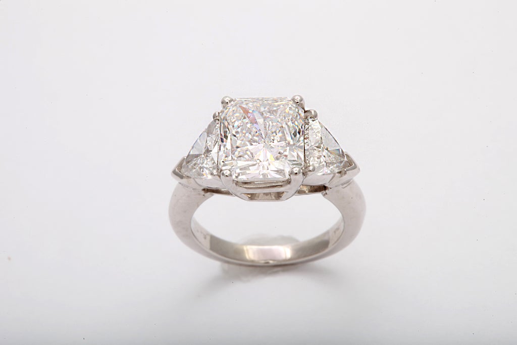 Magnificent 4.00 carat, colorless (GIA F)  very slightly imperfect (GIA VS1) accompanied by GIA report # 8380426<br />
Flanked by 2 triangular mixed cut diamonds 1.36 carats (total weight)