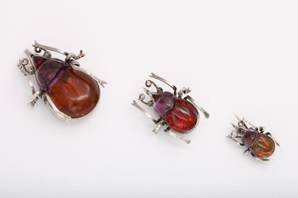 Three cheers for the nuclear family!. Victorian motifs in the mid ninteenth century reflected the natural world. Craftmanship remained detailed as in this family of beetles. They are sterling silver and colorful foiled crystal. The colors have