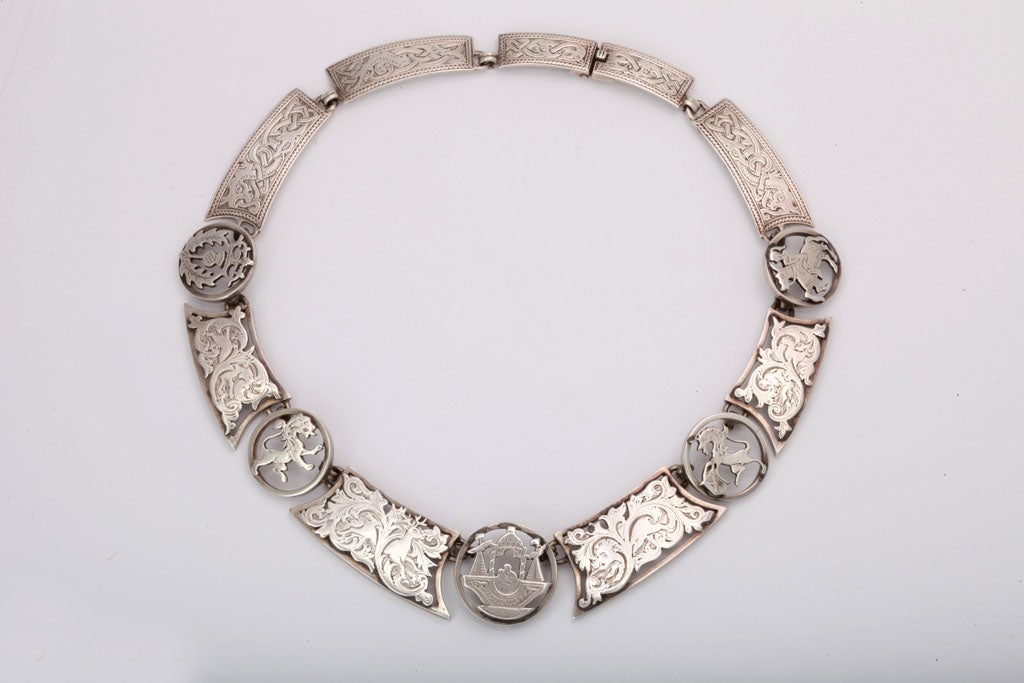 It is infrequent that I find a Scottish Necklace. This striking collar was a surprise.  Oblong links are engraved with scrolling vines, reindeer and celtic knots.  Between the oblongs are circular links showing a ship with two passengers, a prancing