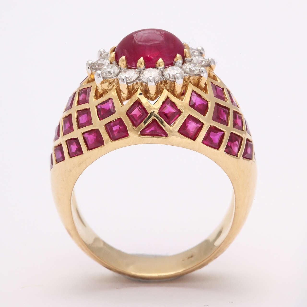 Beautiful Ring set in 18kt Yellow Gold set with Cabochon ruby surrounded by prong set - full cut - clean,  & super white Diamonds.  Balance of ring - lattice set with faceted Rubies .  Tres luxe -