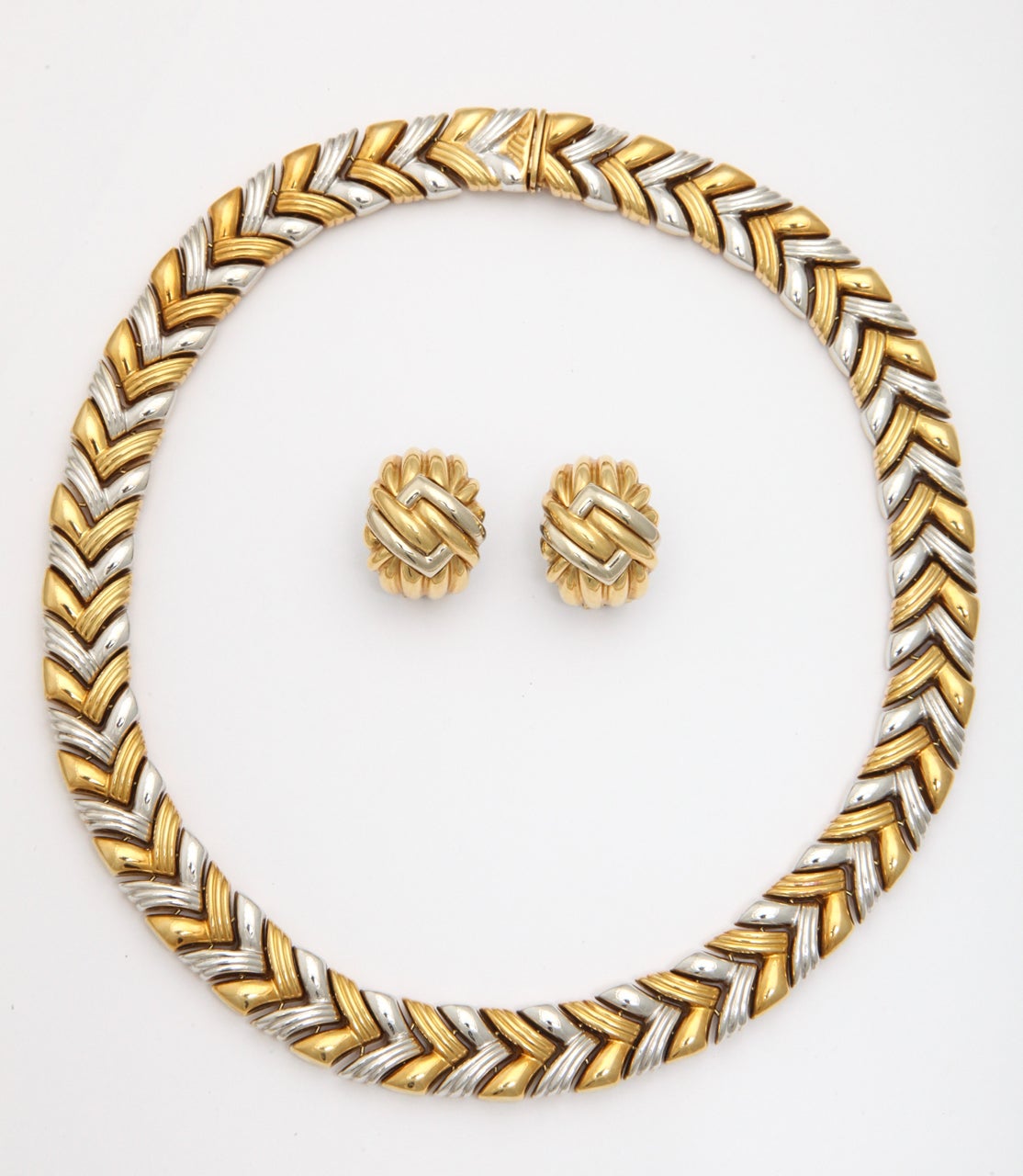 Very unusual chevron shaped 18kt Yellow Gold necklace reversing to solid 18kt Yellow Gold chevron shaped Necklace.  Extremely versatile.   Marked 750 & bearing Italian control marks. Matching Earrings with Omega Backs available.