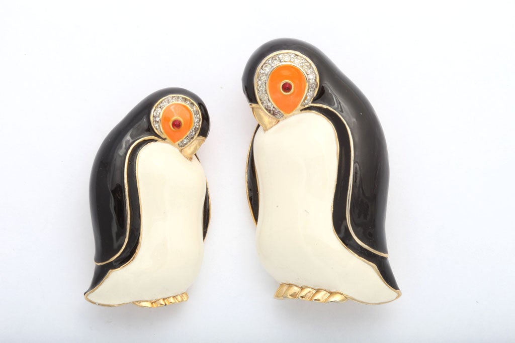 A pair of penguin pins in enamel and clear crystal rhinestone by Judith Leiber. The larger one is 2 1/2
