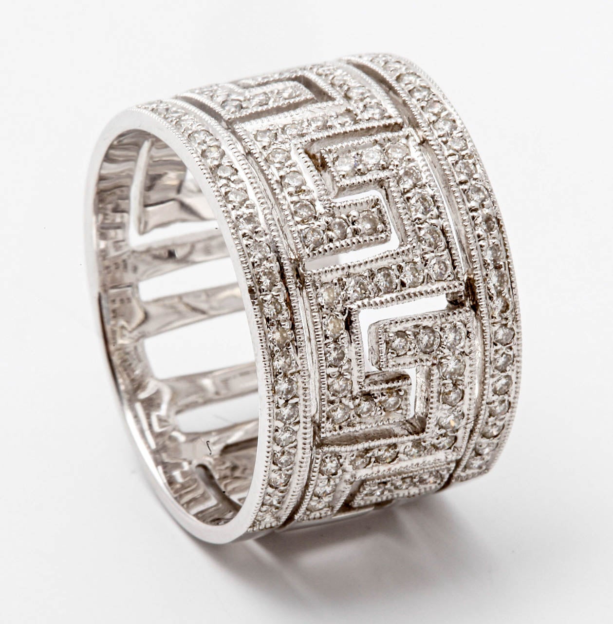 A white gold and diamond ring, the openworked ring decorated with meander motifs, set to the front with brilliant-cut diamonds, with a total diamond weight of approximately 0.50 ct.