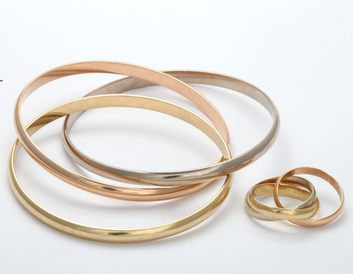 18k yellow, rose and white gold  each band 4.65 mm wide
6 cm diameter
65 grams

matching wedding band  3.37mm each